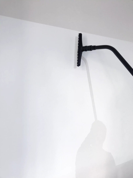 Person using Reach with Sidewinder brush to clean wall. Person using Reach with Sidewinder brush to clean wall.