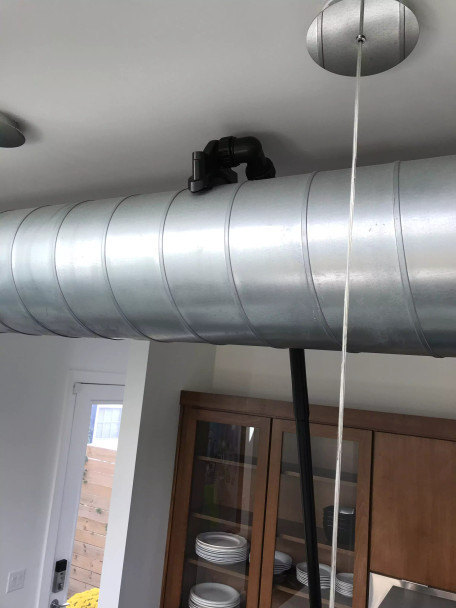 Ventilation tool cleaning ventilation duct in a kitchen.