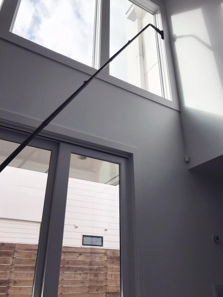 Reach with Sidewinder brush cleaning window sill two stories up.