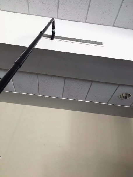 Reach with Sidewinder brush cleaning AC vent near ceiling.