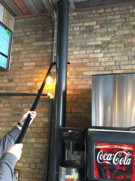 Reach pipe cleaning tool cleaning a pipe.