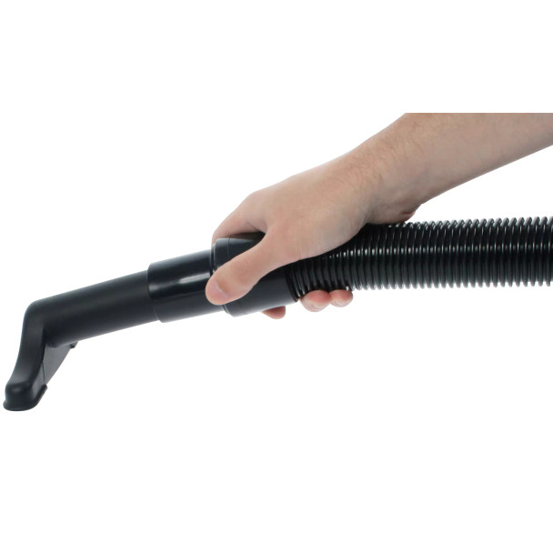 Person holding vacuum hose with upholstery attached.