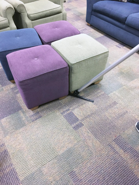 The sidewinder under a set of stools cleaning up dirt.