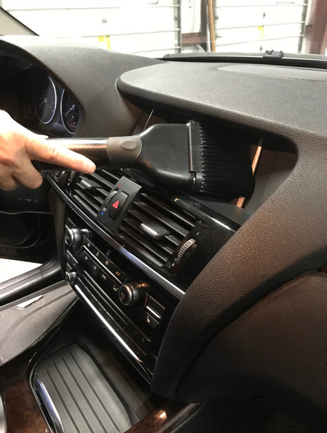 Dust brush cleaning the center console.
