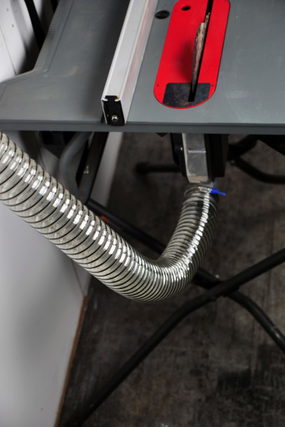 Urethane hose connected to a table saw.