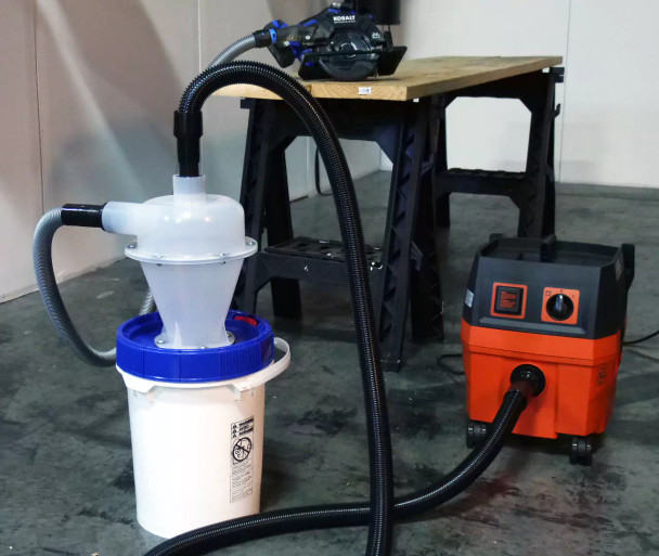 FEIN Turbo I and Quick Click separator bucket connected to circular saw on table.