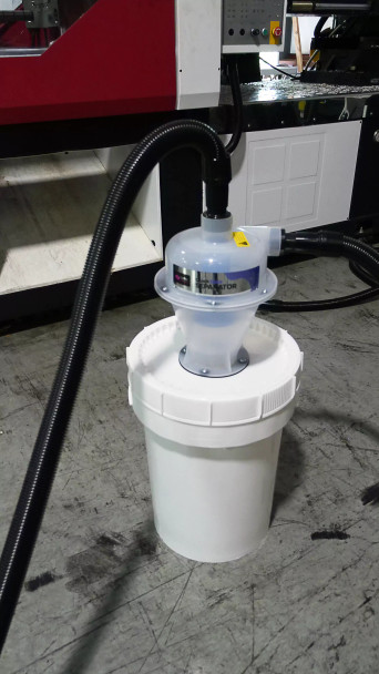 Close up of 12 gallon separator bucket with hoses attached.