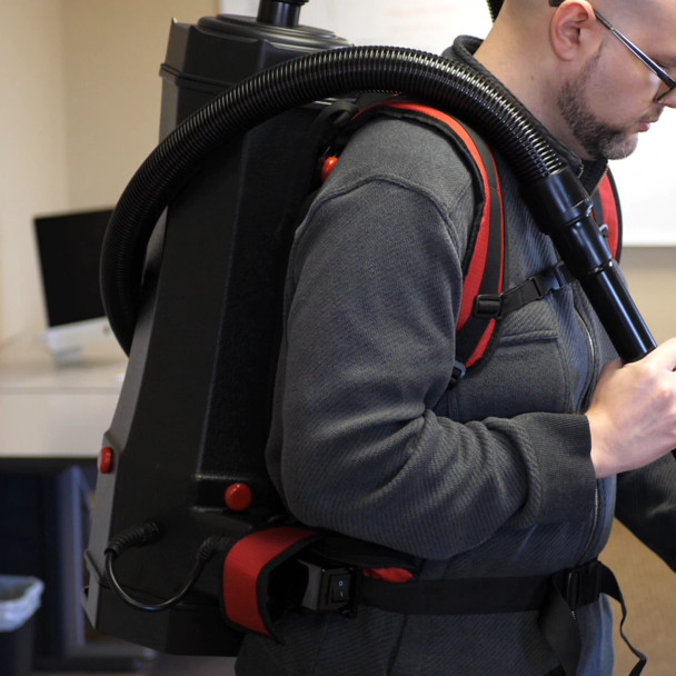 Close up of person wearing a Perfect Power 6 quart backpack vacuum.
