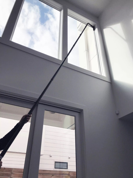 Reach with Sidewinder brush cleaning window sill two stories up.