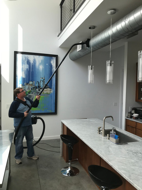 Person using Reach to clean ventilation duct in kitchen.