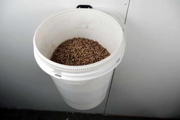 Wood pellets in wall mounted bucket.
