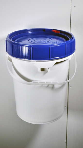 Bucket with lid mounted onto wall.