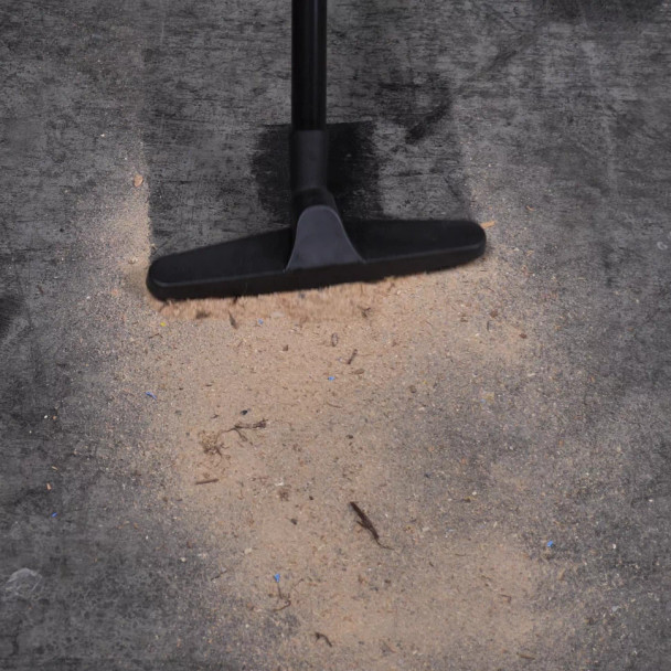 Floor brush cleaning saw dust off of concrete floor.