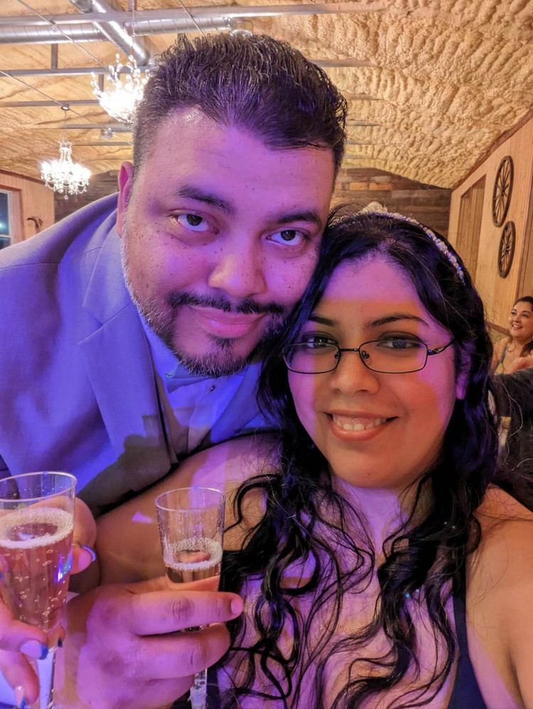 Stalin Lopez, founder of Wild Stallion Mane, and his wife, smiling in a selfie at a celebration