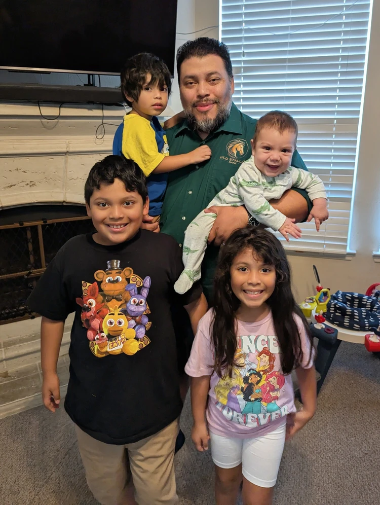 Stalin Lopez, founder of Wild Stallion Mane, at home with his four children
