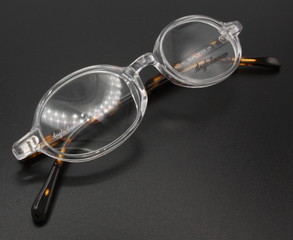 Anglo American 401 oval shaped prescription glasses with a clear front and tortoiseshell effect arms.