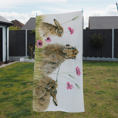 Towel - Poppy Appeal. Hare and leverets. Artwork by Kay Johns