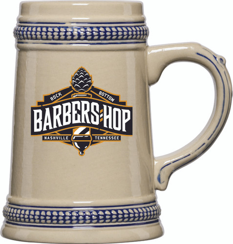 This 0.5L Blue Trim Ceramic Stein with our Barbers Hop Ale logo is the perfect vessel for a mug club, Oktoberfest, or a great addition to your favorite beverage collection.

With its traditional handled design and cobalt blue trim accents, it’s a beautiful and eye-catching stein that your beer fans will love.

Made of durable stoneware, this stein is built to last and will always be in style.