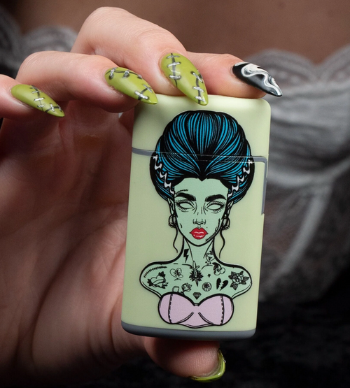 Beautiful Green Flip Torch Lighter featuring the Bride of Frankenstein. A Green Bride of Frankenstein-themed flip torch lighter, featuring the iconic brides hairstyle and a spooky yet stylish design perfect for pre-rolls, candles, and cones