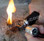 Scraping the Bunker FireSteel to make sparks that light a cotton ball on fire