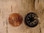 20-mm liquid filled button compass compared to a US penny.  I sprinkle these compasses amongst my gear and clothing to be sure I can always find the direction back to my vehicle or trail head.