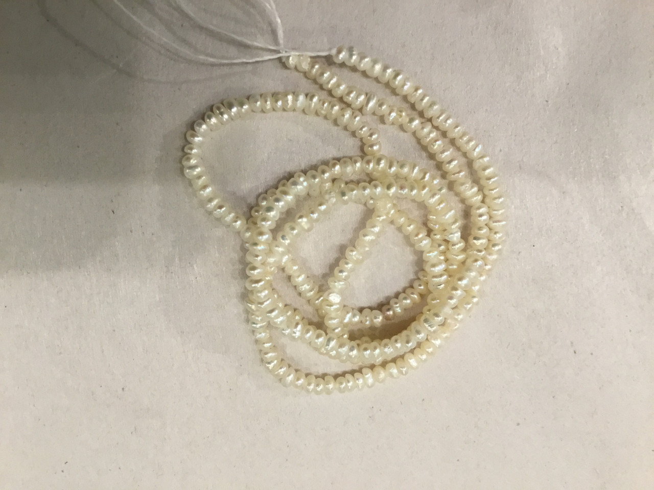 Tiny white pearl strand 