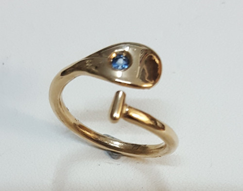 9ct gold , one size fits all- set with a blue sapphire