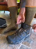 Cozy Cabin Terry Lined Alpaca Crew Socks, Green/Gold on model with work boots.