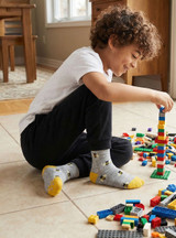 Bee Happy Alpaca Kids Grippy Socks, lifestyle on boy playing lego