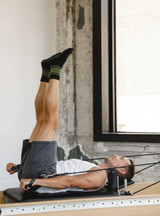 Warrior Retro Crew Grip Socks on a man on a pilates reformer.