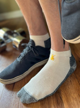 Mini Crew Alpaca Socks with padded foot on model with tennis shoes.