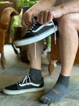 Man putting on  Breakaway Sport Alpaca Quarter-Crew Socks
