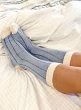 Colorblock Sleep Alpaca Crew Socks On feet relaxing in bed.