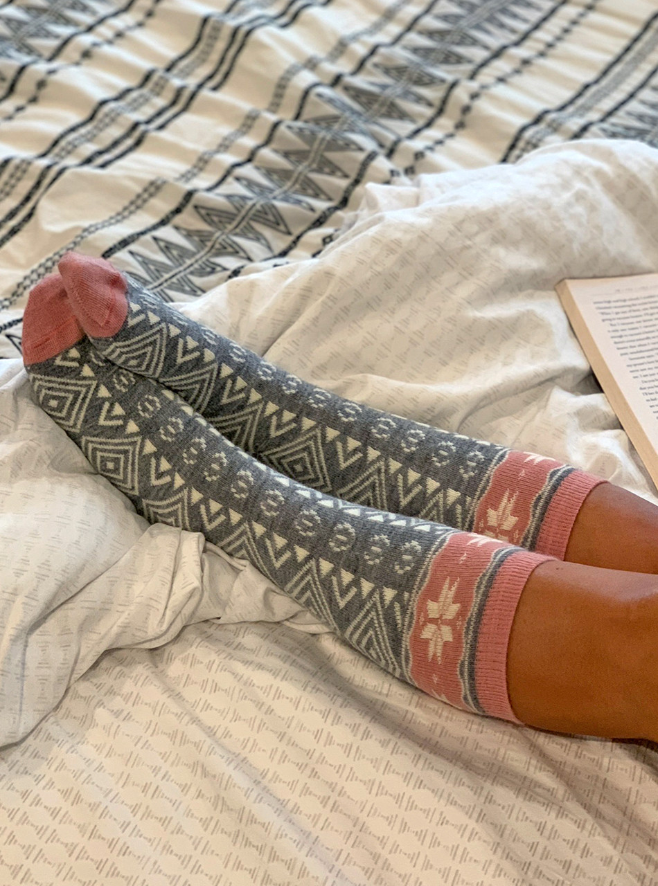 Women's Nordic Star Alpaca Wool Socks 
On legs relaxing on bed.