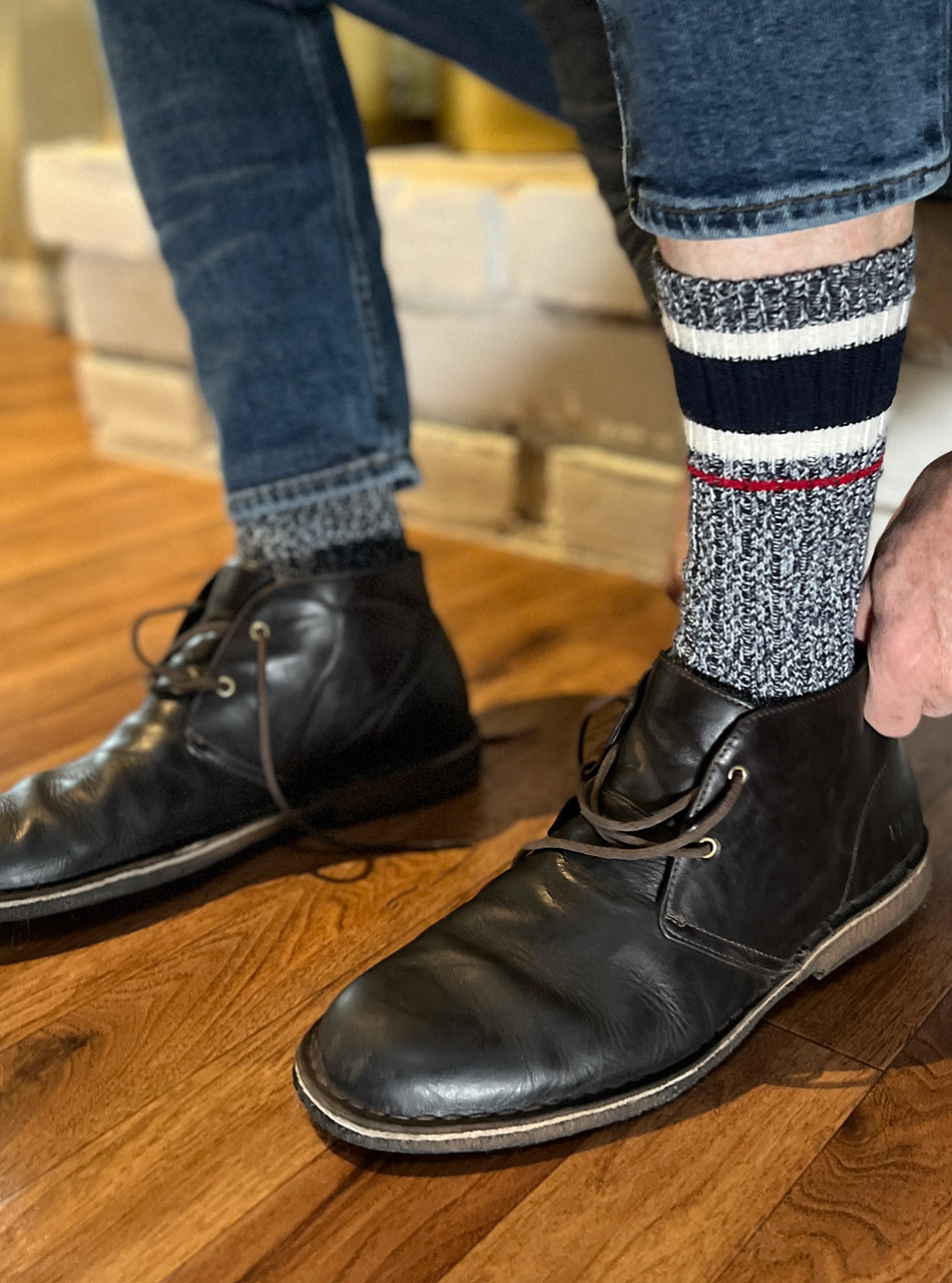 Model putting on Old School Athletic Stripe Alpaca Crew Socks with shoes.