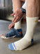 High-Performance Sport Alpaca Crew Socks in White / Blue on Model.