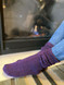 Warrior Alpaca Socks Purple Casual Crew Socks on Model relaxing by fire.