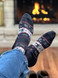 Reindeer Fair Isle Holiday Alpaca Crew Socks Regular Weight on feet relaxing by a cozy warm fire.