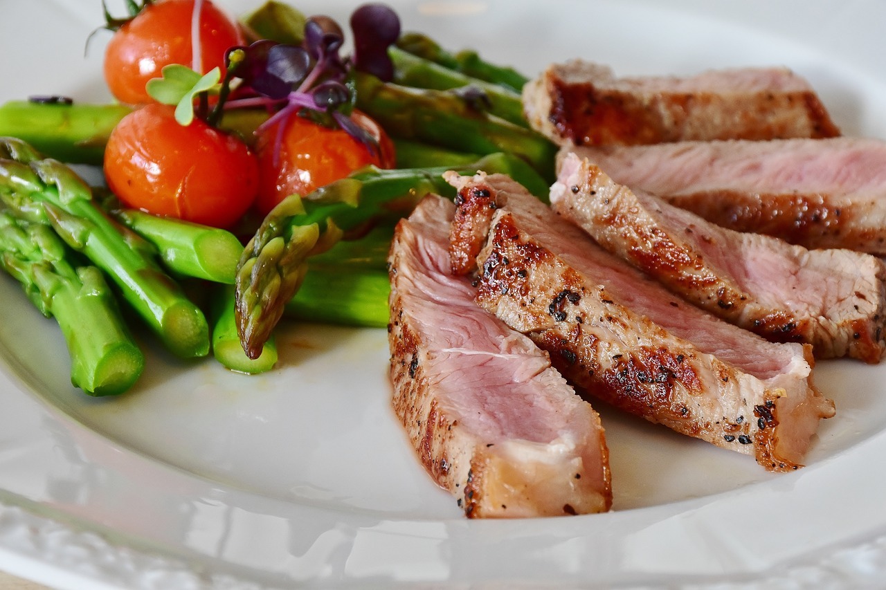 Plate of asparagus, steak, and cherry tomatoes
