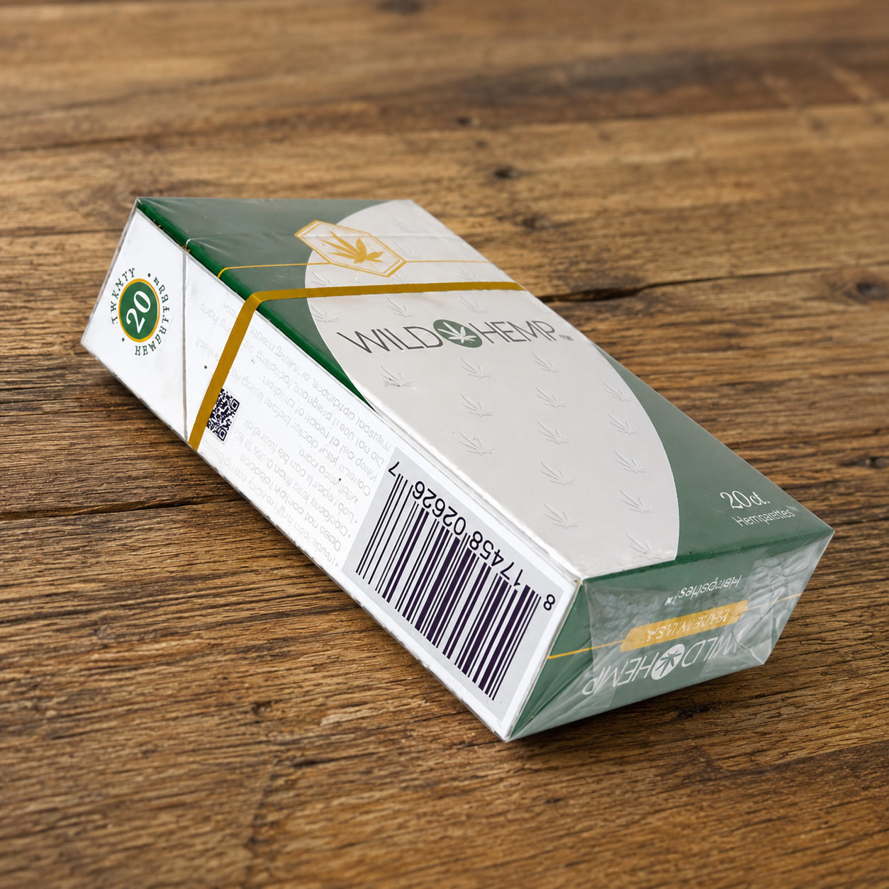 Wild Hemp Hemparettes hemp cigarette pack displayed on a wooden table, illustrating a tobacco-style smokable hemp product.