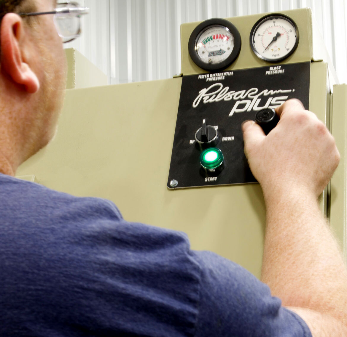 A person adjusting knobs on control panel
