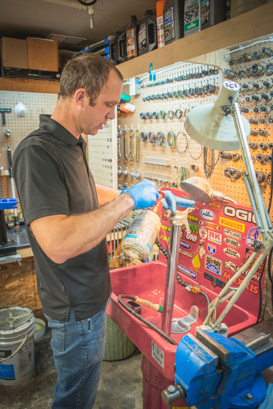 Chuck Harder working on a fork leg at the shop parts washer