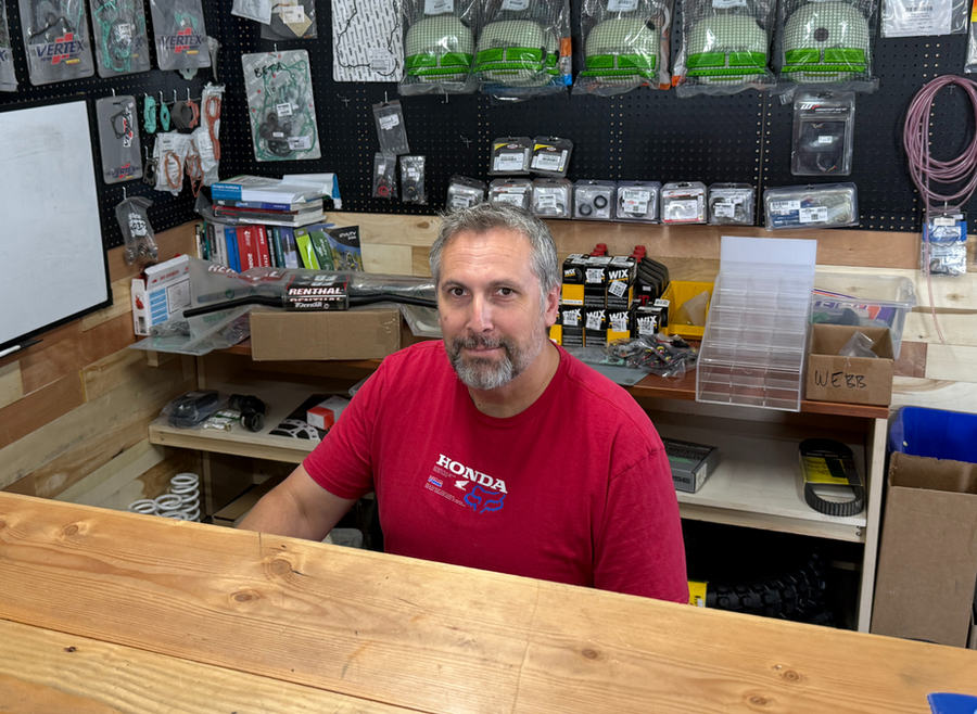George Merry behind the parts counter in the shop