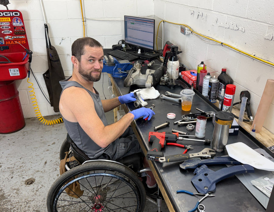 Troy Morrison working on parts at his shop workbench