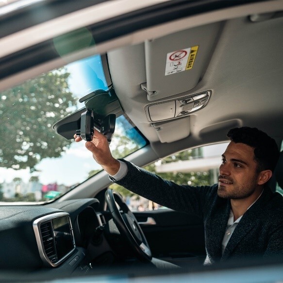 Driver inside a car using a Nextbase Dash Cam