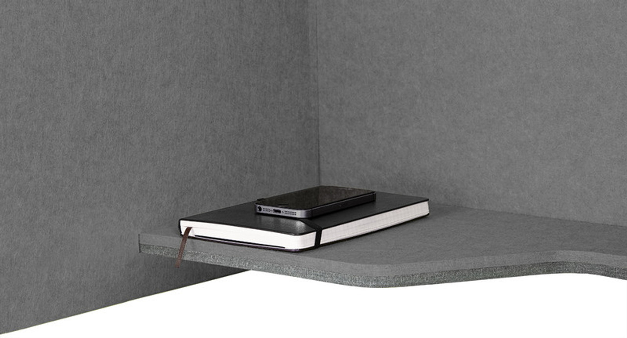 The Acoustic Wall-Mounted Phone Booth even comes with a handy shelf to store lightweight items, like notebooks The Acoustic Wall-Mounted Phone Booth even comes with a handy shelf to store lightweight items, like notebooks