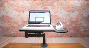 The UPLIFT Laptop Mount for Monitor Arms' rotating platform provides space for small item or mouse storage