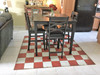 Classic Pattern 7 Checked Out (distressed)- vinyl floor cloth used in a dining room