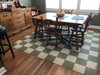 Classic Pattern 7 Check Please (distressed)- vinyl floor cloth used in a dining room 