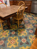 Pattern 33 Ballyhoo - vinyl floor cloth 120x120 square size used under a dining table 